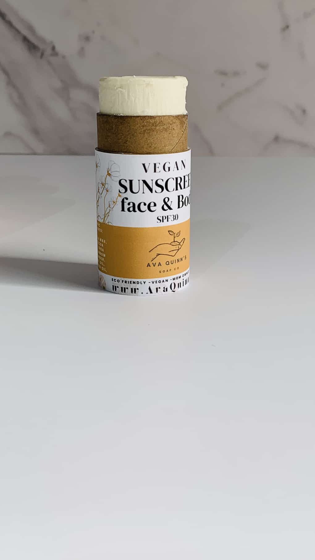 Vegan sunscreen bottle with natural ingredients for face and body protection