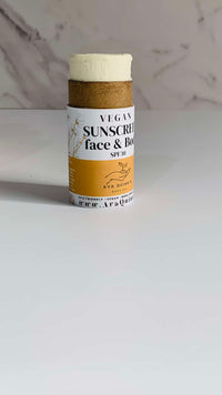 Vegan sunscreen bottle with natural ingredients for face and body protection