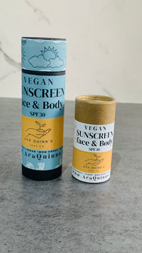 Vegan sunscreen bottle with natural ingredients for face and body protection