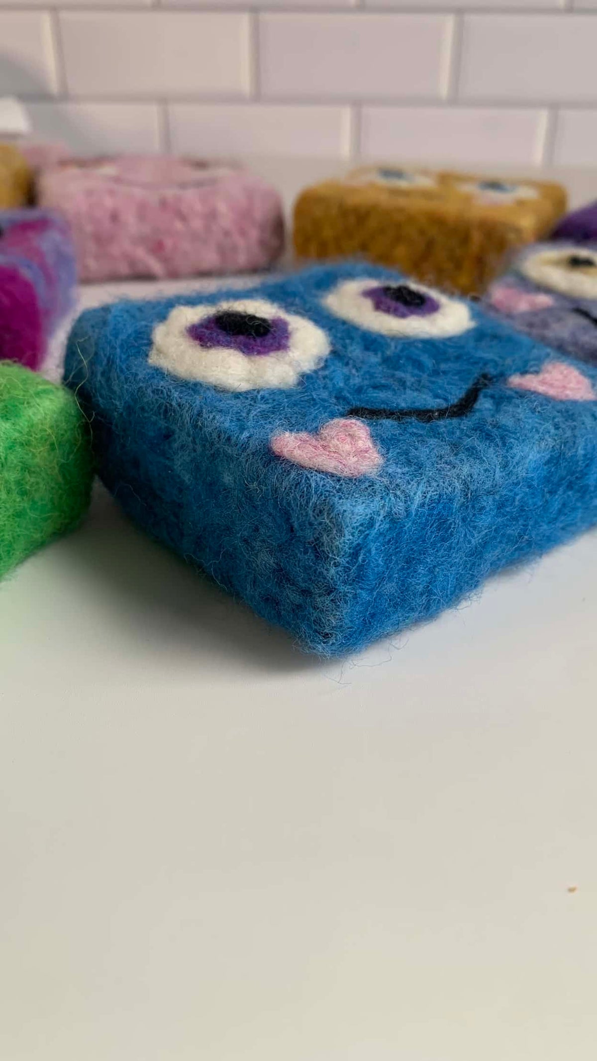 Adorable felted soap monster in vibrant colors, perfect for kids' bath time routines.