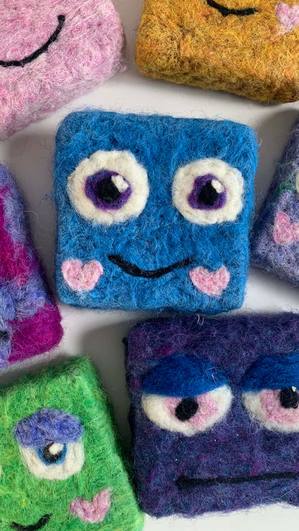 Adorable felted soap monster in vibrant colors, perfect for kids' bath time routines.